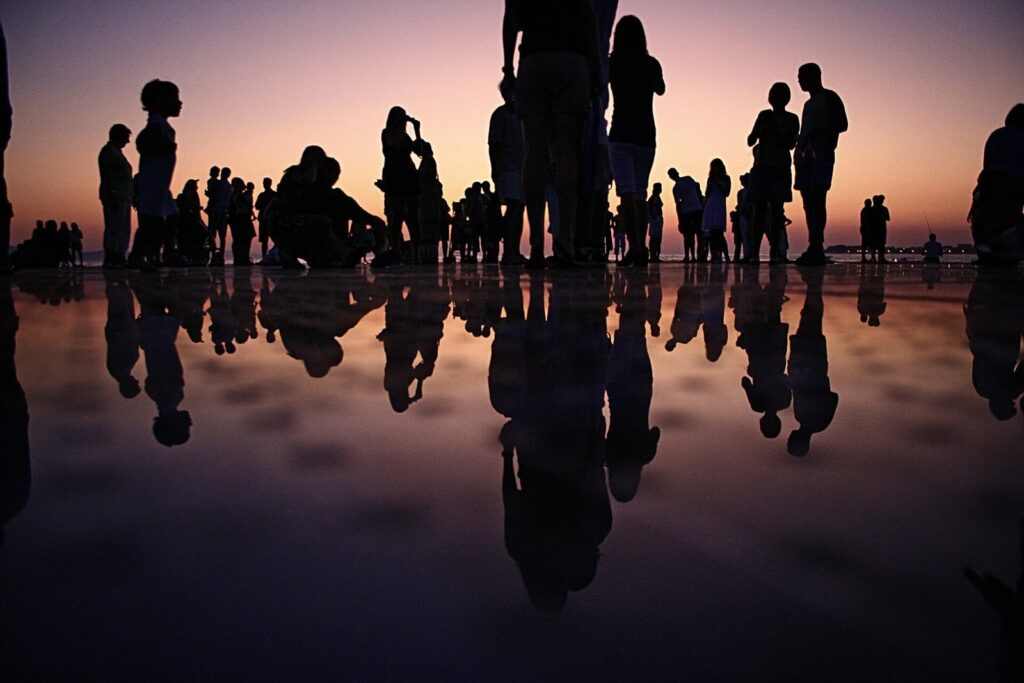 Crowd silhouetted at dusk at an outdoor gathering