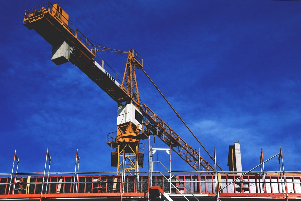 Construction cranes against the sky